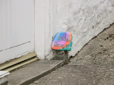 a sticker on the side of a building at The Old Brewery Store in Gatehouse of Fleet
