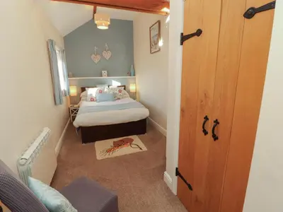 a small bedroom with a bed in a room at The Old Grainstore in Wigton
