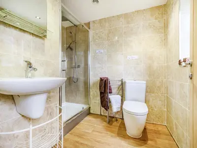 a bathroom with a toilet and a sink and a shower at Solway Cottage in Bowness-on-Solway
