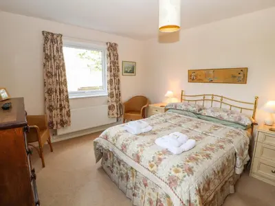 a bedroom with a bed with two towels on it at West Croft in Mawbray