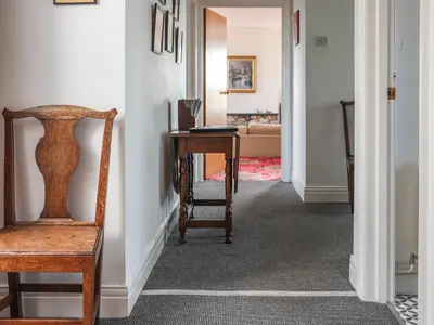 a hallway with a chair and a desk in a room at West Croft in Mawbray