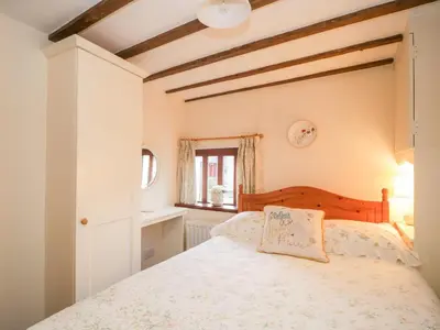 a bedroom with a bed and a window at Stable End Cottage in Nether Wasdale