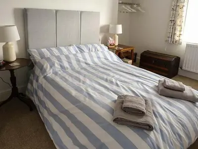 a bedroom with a bed with towels on it at Fish House in Kirkcudbright