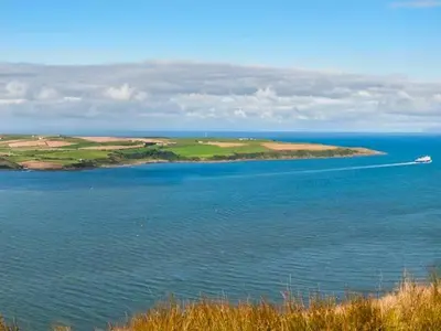 a boat in the middle of a large body of water at Little Laight in Cairnryan