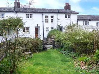 a white house with a fence and a yard at Littlebeck in Rosthwaite