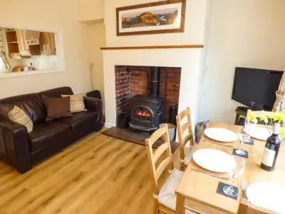 a living room with a couch and a fireplace at Littlebeck in Rosthwaite