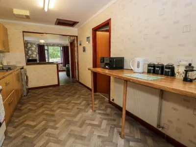a kitchen with a counter and a counter top at Torkeld Holiday Cottage in Garlieston