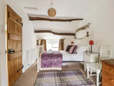 a bedroom with a bed and a desk at Barn Roost in Uldale