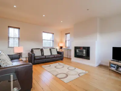 a living room with a couch and a fireplace at Wrenville in Keswick