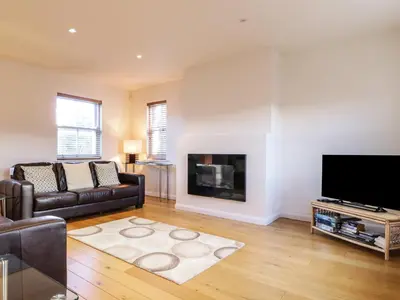 a living room with a couch and a fireplace at Wrenville in Keswick