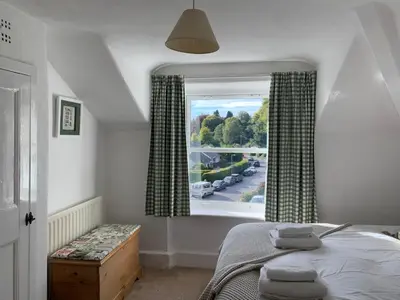 a bedroom with a bed and a large window at Prospect Lodge in Portinscale