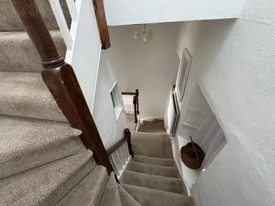 a winding stairway with a stair case in a house at Prospect Lodge in Portinscale