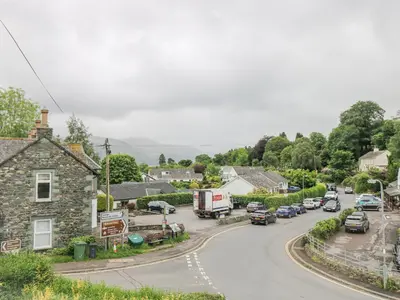 a small village with cars parked on the road at Prospect Lodge in Portinscale