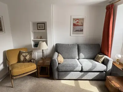 a living room with a couch and a chair at Prospect Lodge in Portinscale