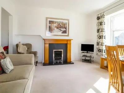 a living room with a couch and a fireplace at Helvellyn in Keswick