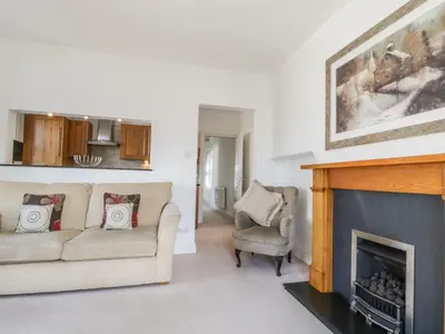 a living room with a couch and a fireplace at Helvellyn in Keswick