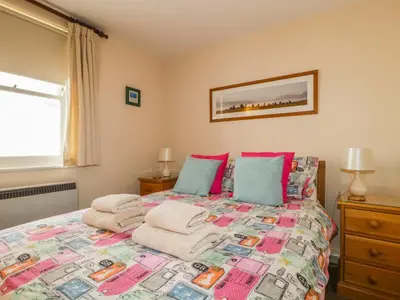 a bedroom with a bed with towels on it at Castlerigg in Keswick