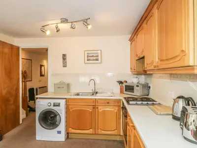 a kitchen with a sink and a washing machine at Castlerigg in Keswick