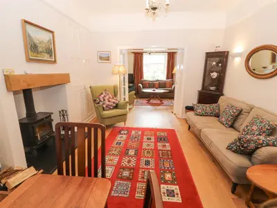 a living room with a couch and a table at White House in Keswick
