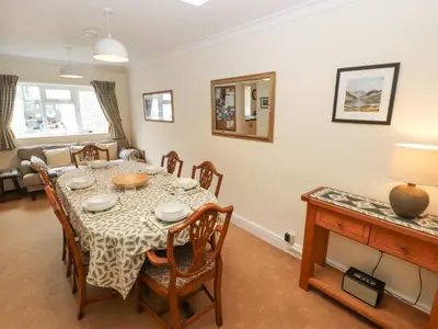 a dining room with a table and chairs at White House in Keswick