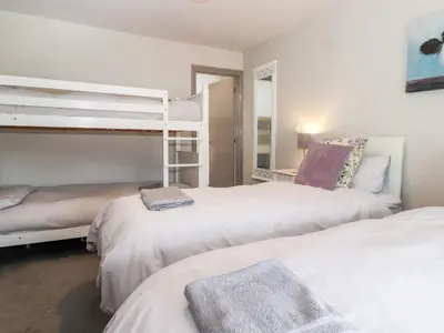 two beds in a room with two bunk beds at Latrigg House in Keswick