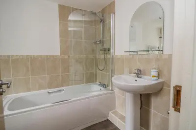 a bathroom with a sink and a bath tub and a sink at Derwentwater Apartment in Keswick