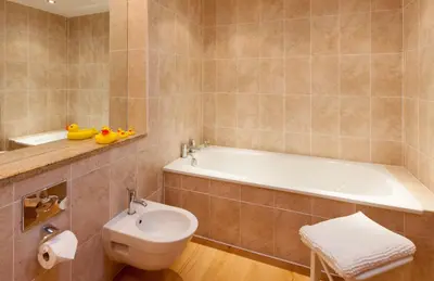 a bathroom with a tub and a toilet and a sink at Heads Nook Hall Cottage in Carlisle