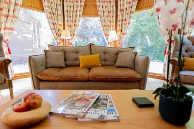 a living room with a couch and a table at Heads Nook Hall Cottage in Carlisle