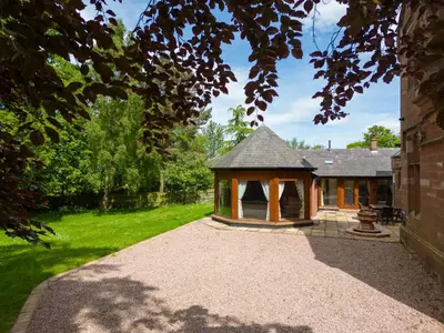 a gazebo in the yard of a house at Heads Nook Hall Cottage in Carlisle