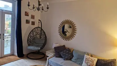 a living room with a mirror and a couch at Troon Beachcombers in Troon