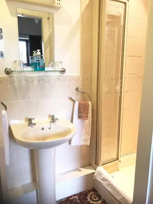 a bathroom with a sink and a shower at Ferintosh Guest House in Dumfries