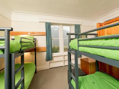 a bunk bed room with two bunk beds and a window at YHA Buttermere in Buttermere