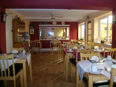 a restaurant with tables and chairs in a room at Arkale Lodge in Carlisle