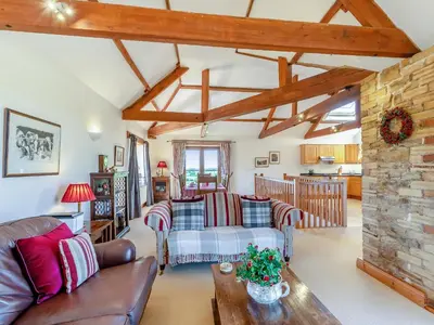 a living room with a couch and a table at New Park Farm - Church Cottage in Ireby