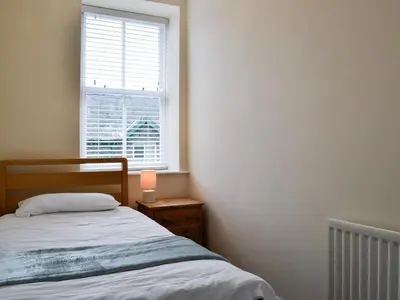a bedroom with a bed and a window at Walla Crag in Keswick