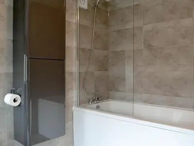 a bathroom with a tub and a shower with a glass door at Walla Crag in Keswick