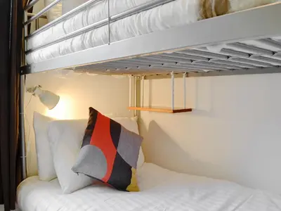 a bedroom with a bunk bed with a pillow at Philip's Cottage in Keswick