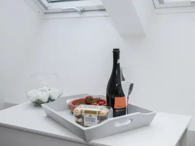 a bottle of champagne and cheese and a bowl of tomatoes at The Hoggest in Threlkeld