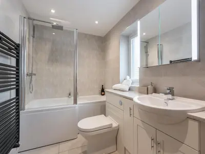 a bathroom with a toilet and a sink and a shower at The Hoggest in Threlkeld