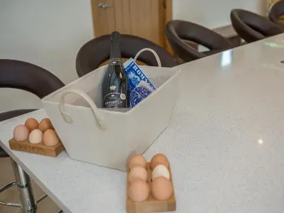 a box of eggs and a bottle of wine on a table at The Hoggest in Threlkeld