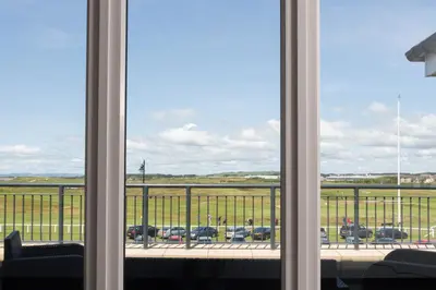 a window with a view of a parking lot at Links View - Donnini Deluxe in Prestwick