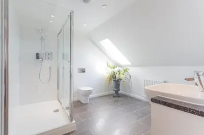 a bathroom with a shower and a sink and a toilet at Links View - Donnini Deluxe in Prestwick