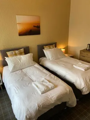 two beds sitting next to each other in a room at No 4 Portpatrick B&B in Portpatrick