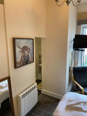 a room with a painting of a bull on the wall at No 4 Portpatrick B&B in Portpatrick