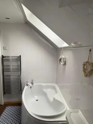 a white bathroom with a tub and a shower at The Craighlaw Hideaway A Peaceful Village Escape 2 Bedroom Apartment with Garden in Kirkcowan