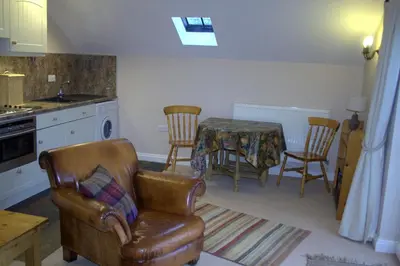 a living room with a table and chairs and a couch at StoneyGill in Keswick
