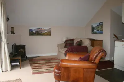 a living room with a couch and a chair at StoneyGill in Keswick