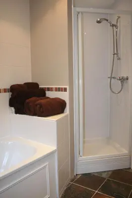 a bathroom with a sink and a shower and towels at StoneyFell in Keswick