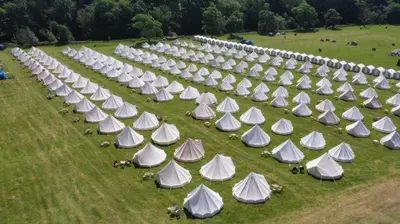 an aerial view of a field with many white tents at IntentsGP @ Isle of Man TT, IOMTT in Douglas