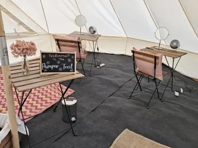 a marquee with two tables and chairs in a tent at IntentsGP @ Isle of Man TT, IOMTT in Douglas
